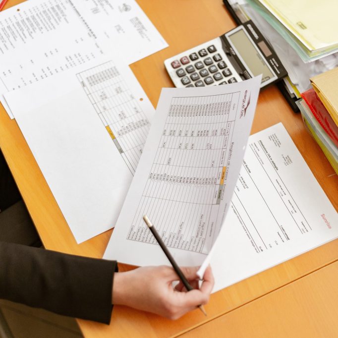 person-holding-white-printer-paper-and-pen-2058136